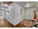 Bright hallway features wood floors, white walls, decorative rug, and access to multiple rooms at 3140 Unicorn Ave, Pahrump, NV 89048