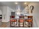 Kitchen with barstool seating, white cabinets, and gray countertops at 3140 Unicorn Ave, Pahrump, NV 89048