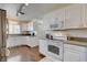 A white kitchen with stainless steel appliances and hard wood floors at 3140 Unicorn Ave, Pahrump, NV 89048