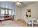 Living room area with decorative bookshelves, rocking chair, and white table set at 3140 Unicorn Ave, Pahrump, NV 89048