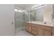 Bathroom features double sink vanity and glass enclosed shower at 3320 Helmsman Dr, North Las Vegas, NV 89032