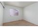 Bedroom features neutral carpet and paint, with a single window for natural light at 3320 Helmsman Dr, North Las Vegas, NV 89032