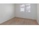 Bedroom features neutral carpet and paint, with a single window for natural light at 3320 Helmsman Dr, North Las Vegas, NV 89032