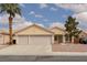 Charming single-story home features a two-car garage, desert landscaping, and a tiled roof at 3320 Helmsman Dr, North Las Vegas, NV 89032