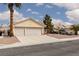 Inviting home boasts a spacious driveway, xeriscaping, and a classic tile roof at 3320 Helmsman Dr, North Las Vegas, NV 89032