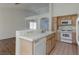 Bright kitchen features white appliances, tiled countertops, and updated cabinets at 3320 Helmsman Dr, North Las Vegas, NV 89032