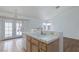 Kitchen view featuring tiled countertop with stainless steel faucet and doors to patio at 3320 Helmsman Dr, North Las Vegas, NV 89032