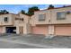 Row of condominium units featuring stone facades and two-car garages, providing comfortable living at 3380 Dusa Dr, Las Vegas, NV 89121