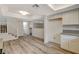 Open living area with staircase and light wood-look floors. Kitchen and dining area can be seen at 3380 Dusa Dr, Las Vegas, NV 89121