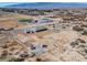 Expansive property featuring multiple outbuildings, mature landscaping, and mountain views in an open desert setting at 3600 E Bridger St, Pahrump, NV 89061