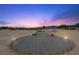 Expansive backyard featuring desert landscaping and an intricate lighting scheme at 3600 E Bridger St, Pahrump, NV 89061