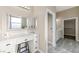 Well-lit bathroom with a vanity, seated makeup area, drawers for storage and a large framed mirror at 3600 E Bridger St, Pahrump, NV 89061