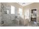 Bright bathroom features a tiled shower, soaking tub, and neutral colors at 3600 E Bridger St, Pahrump, NV 89061