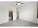 Spacious bedroom with tiled floors, modern fan, and ensuite bathroom at 3600 E Bridger St, Pahrump, NV 89061