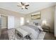 Comfortable bedroom featuring wood look tile floors, crown molding, and a calming neutral color palette at 3600 E Bridger St, Pahrump, NV 89061