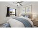 Bedroom with a ceiling fan, window, and framed artwork above the bed at 3600 E Bridger St, Pahrump, NV 89061
