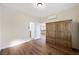 Spacious bedroom featuring wood floors, a wardrobe and open access to bathroom and kitchen at 3600 E Bridger St, Pahrump, NV 89061