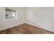 Bright bedroom featuring wood-look floors and a window for natural light at 3600 E Bridger St, Pahrump, NV 89061