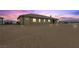 Exterior view of home and desert landscape, enhanced by the desert sunset at 3600 E Bridger St, Pahrump, NV 89061