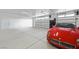 Spacious garage with epoxy floor and parked red sports car at 3600 E Bridger St, Pahrump, NV 89061