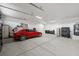 Garage featuring epoxy flooring and parked red sports car at 3600 E Bridger St, Pahrump, NV 89061