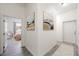 Hallway featuring modern artwork, neutral paint and gray-tone wood-look flooring at 3600 E Bridger St, Pahrump, NV 89061