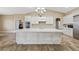 Bright kitchen featuring white cabinetry, stainless appliances, and an oversized center island at 3600 E Bridger St, Pahrump, NV 89061