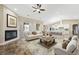 Open-concept living room with a fireplace and seamless flow to dining and kitchen at 3600 E Bridger St, Pahrump, NV 89061