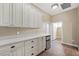 Well-organized pantry with ample storage space, white cabinets, quartz countertop, and a mini fridge at 3600 E Bridger St, Pahrump, NV 89061
