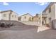 Large gravel backyard with outdoor seating and a second-story balcony at 3632 Julia Waldene Ct, Las Vegas, NV 89129