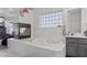 Bright bathroom featuring a soaking tub and a glass block window for privacy at 3632 Julia Waldene Ct, Las Vegas, NV 89129