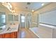 Bright bathroom with double sinks, soaking tub, and glass shower, perfect for relaxation at 3958 Blushing Hearts Rd, Las Vegas, NV 89115
