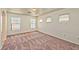 Spacious, carpeted bedroom featuring multiple windows, allowing for ample natural light at 3958 Blushing Hearts Rd, Las Vegas, NV 89115