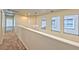 Upstairs hallway featuring large windows at 3958 Blushing Hearts Rd, Las Vegas, NV 89115