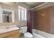 Bathroom with tile surround, shower, toilet, and wooden vanity at 4155 Comb Cir, Las Vegas, NV 89104