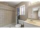Full bathroom featuring a tub shower with tiled walls and a single sink vanity at 4155 Comb Cir, Las Vegas, NV 89104