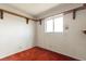 A simple bedroom with shelving and a window for natural light at 4155 Comb Cir, Las Vegas, NV 89104