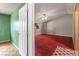 Bedroom featuring red carpet, ceiling fan, and view of the second floor at 4155 Comb Cir, Las Vegas, NV 89104