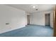 Large bedroom with blue carpeting, white walls, and multiple doors at 4155 Comb Cir, Las Vegas, NV 89104