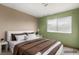 Virtually staged bedroom with white headboard and neutral color scheme at 4155 Comb Cir, Las Vegas, NV 89104