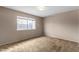 Bedroom with a window overlooking the backyard, and carpeted floors at 4155 Comb Cir, Las Vegas, NV 89104