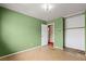 Bedroom featuring green walls, a window, and tile-pattern flooring at 4155 Comb Cir, Las Vegas, NV 89104