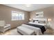Bright bedroom with modern furnishings, large window and neutral color palette at 4155 Comb Cir, Las Vegas, NV 89104