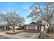 Charming single-story home with brick accents, mature trees and a driveway at 4155 Comb Cir, Las Vegas, NV 89104