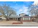 Charming single-story home with brick accents, mature trees and a driveway at 4155 Comb Cir, Las Vegas, NV 89104