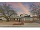 Charming single-story home with brick accents, mature trees and a driveway at 4155 Comb Cir, Las Vegas, NV 89104
