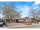 Charming single-story home with brick accents, mature trees and a driveway at 4155 Comb Cir, Las Vegas, NV 89104