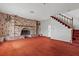 View of the living room with a large brick fireplace and staircase at 4155 Comb Cir, Las Vegas, NV 89104