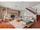 Contemporary living room with a brick fireplace, modern furniture, and stylish decor, creating a sophisticated living space at 4155 Comb Cir, Las Vegas, NV 89104