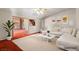 Staged living room featuring a white sofa, a large rug, and open floor plan at 4155 Comb Cir, Las Vegas, NV 89104